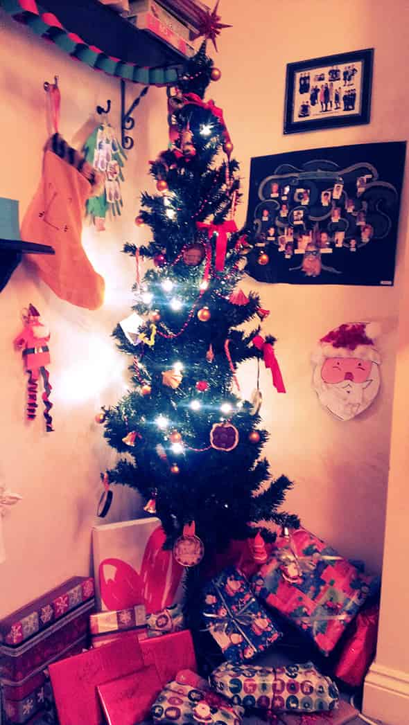 The dressed Christmas tree surrounded by Christmas decorations.